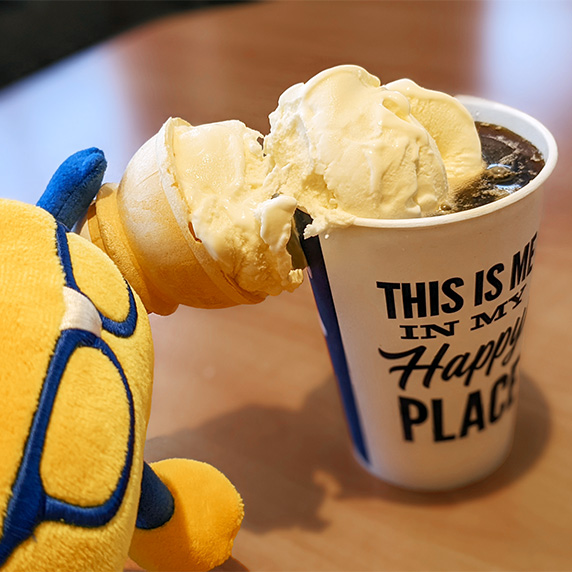 Curdis plushie takes Vanilla Fresh Frozen Custard from cone and places inside root beer