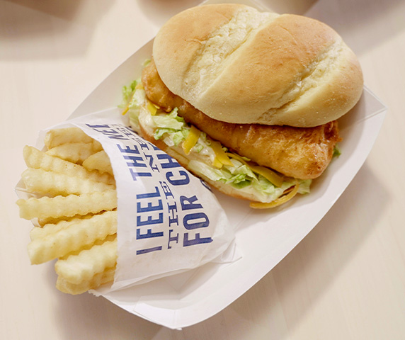 North Atlantic Cod Sandwich with Crinkle Cut Fries placed in a basket.