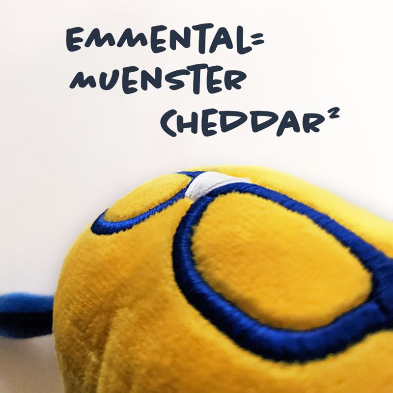 Curdis looking at a cheesy equation written on a whiteboard, emmental=muenster cheddar squared.