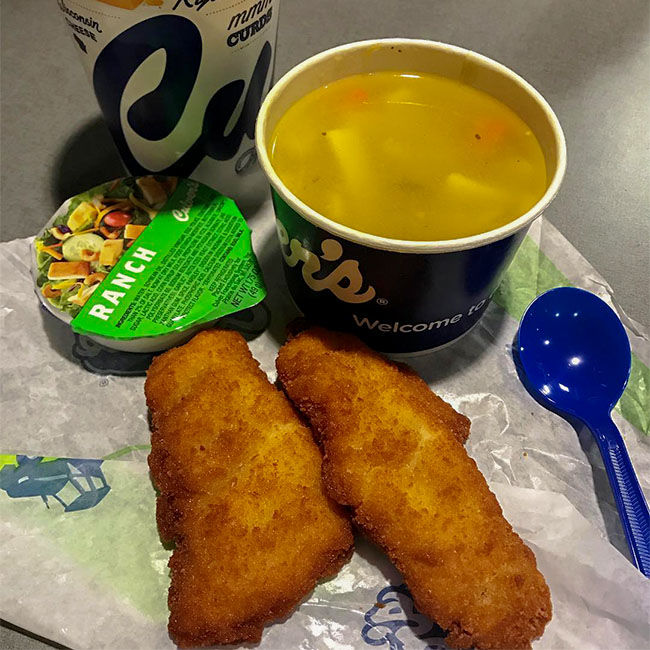 Two Culver’s Chicken Tenders lay next to a bowl of soup.
